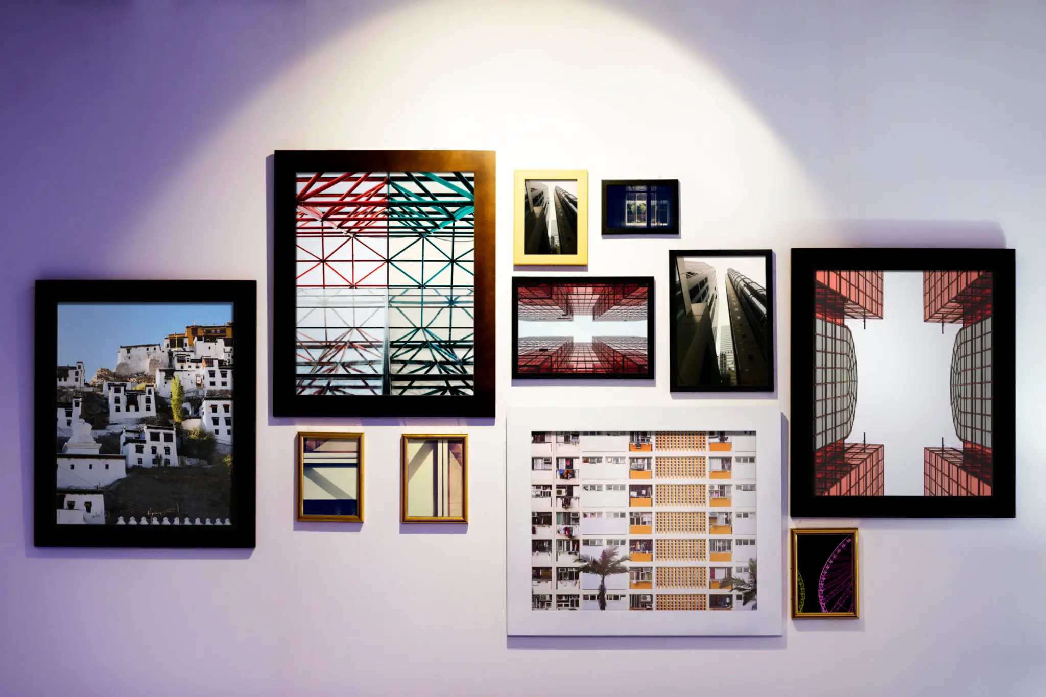 Artwork and Pictures in frames on a white wall.